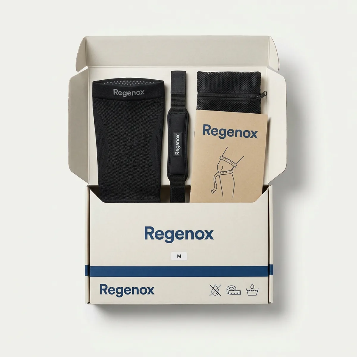 Regenox Knee Support Set in an open kraft-white box: knitted knee sleeve, patella strap, mesh wash bag and A5 printed guide